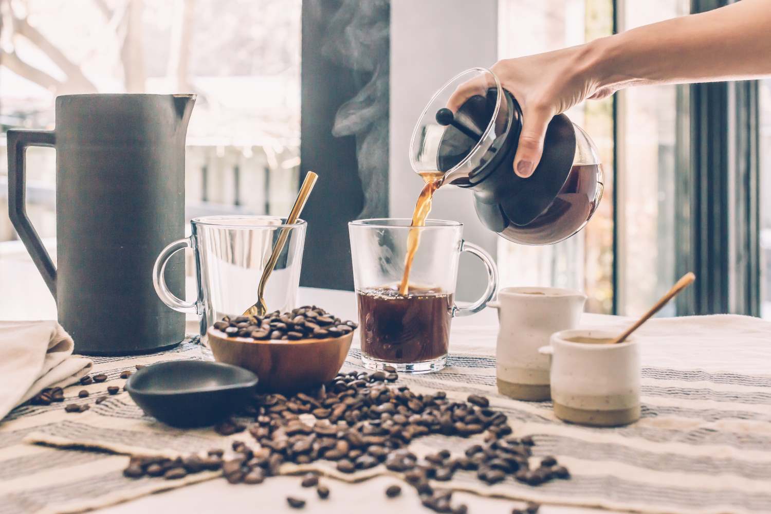 person pouring coffee from pot